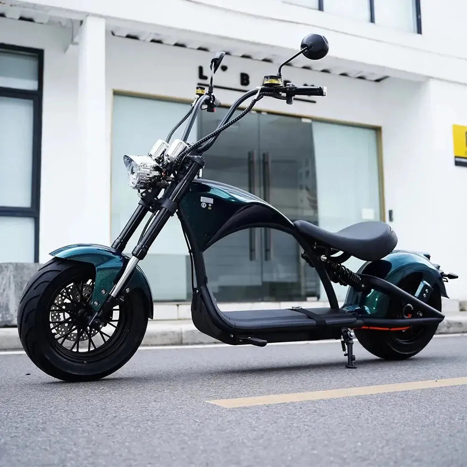 Black electric scooter on a city street with a building in the background