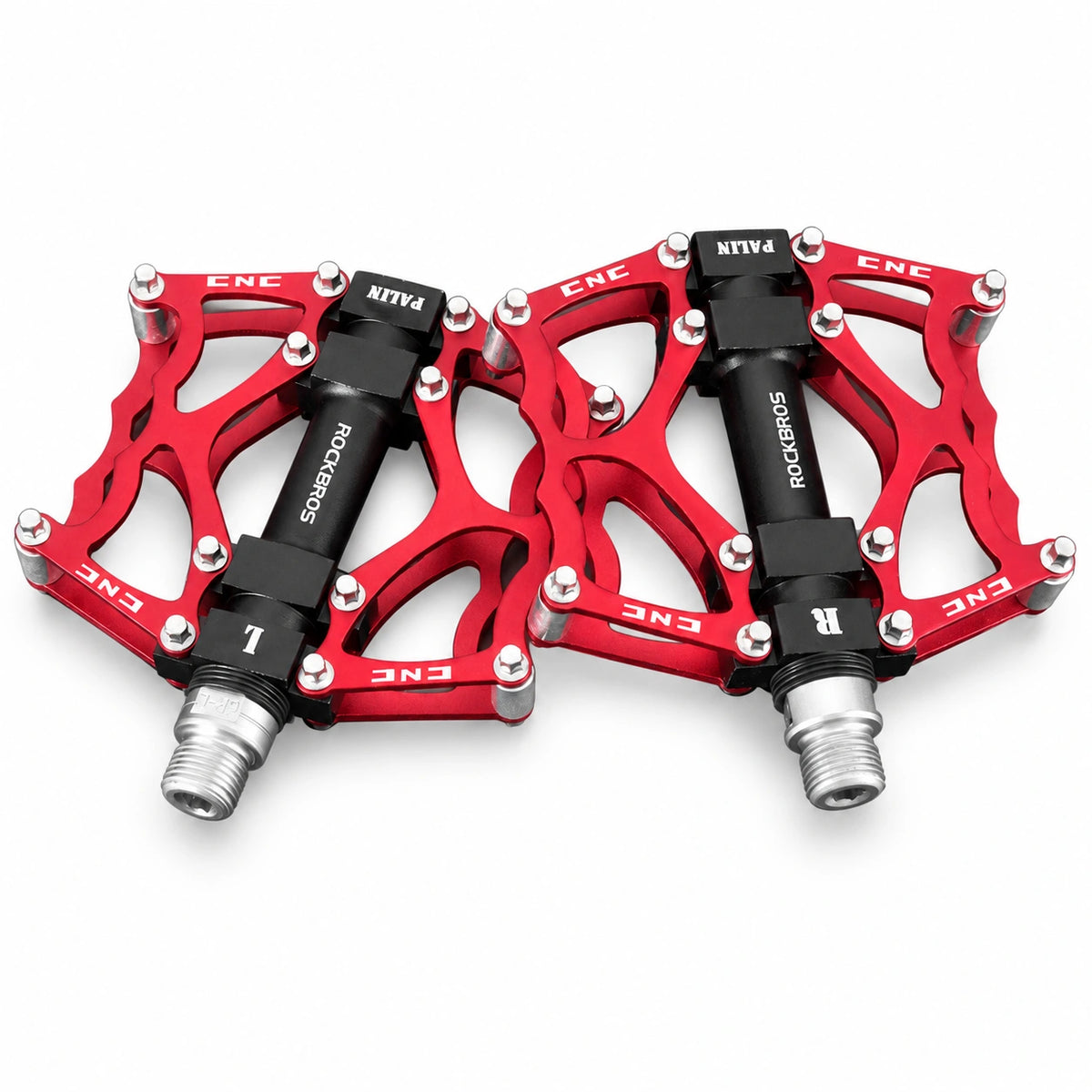 Red bicycle platform pedal pair on white background