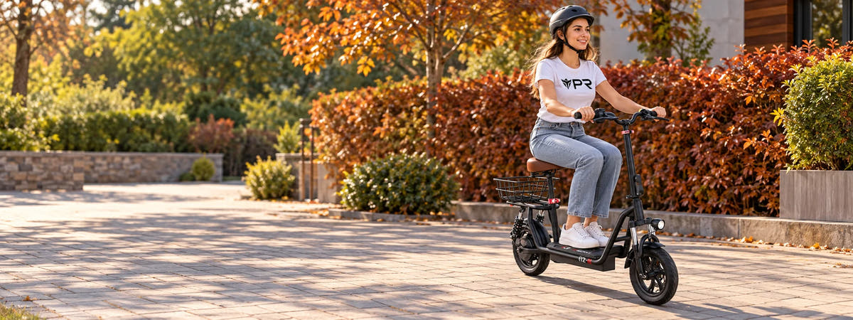 A helmeted rider wearing a white Punk Ride logo T-shirt rides the ISCOOTER i12 Electric Scooter in an autumn setting. Desktop collection banner.