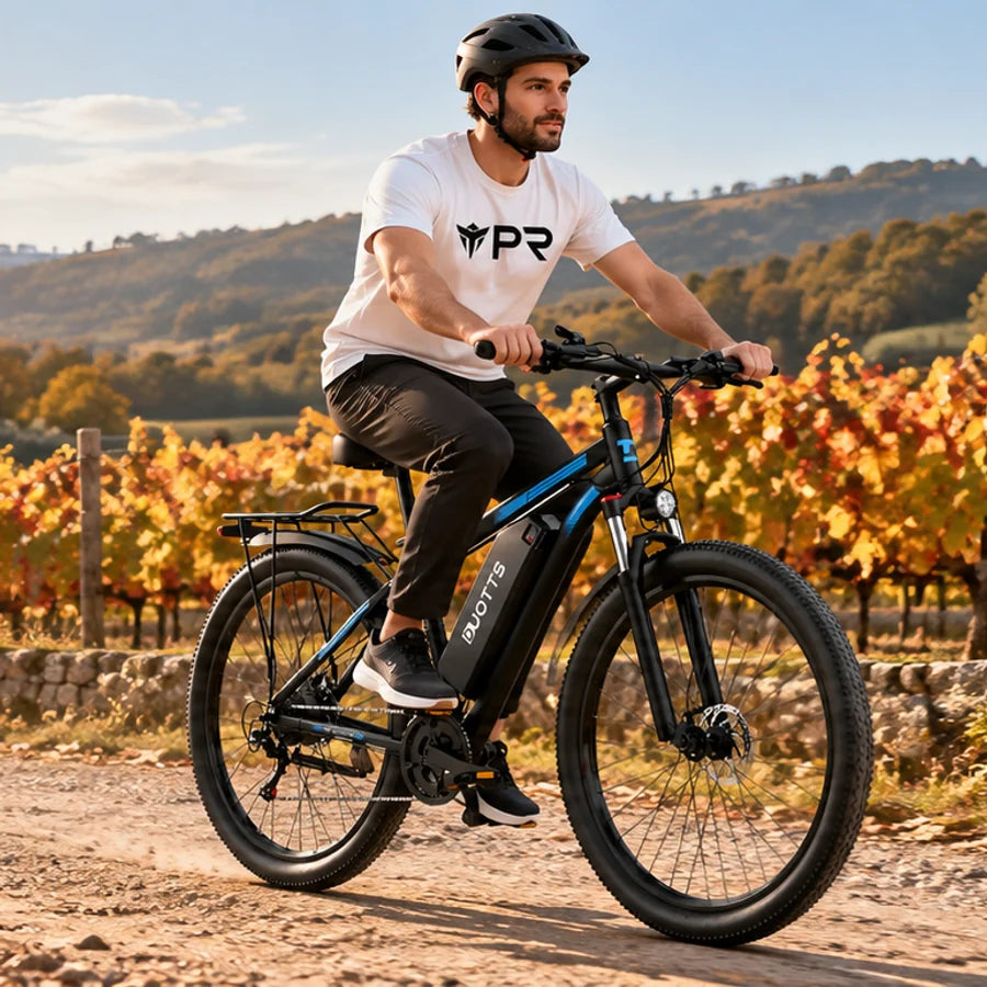 A helmeted rider wearing a white Punk Ride logo T-shirt rides the DUOTTS C29 Electric Bike with Single Battery in an autumn setting. Mobile collection banner.