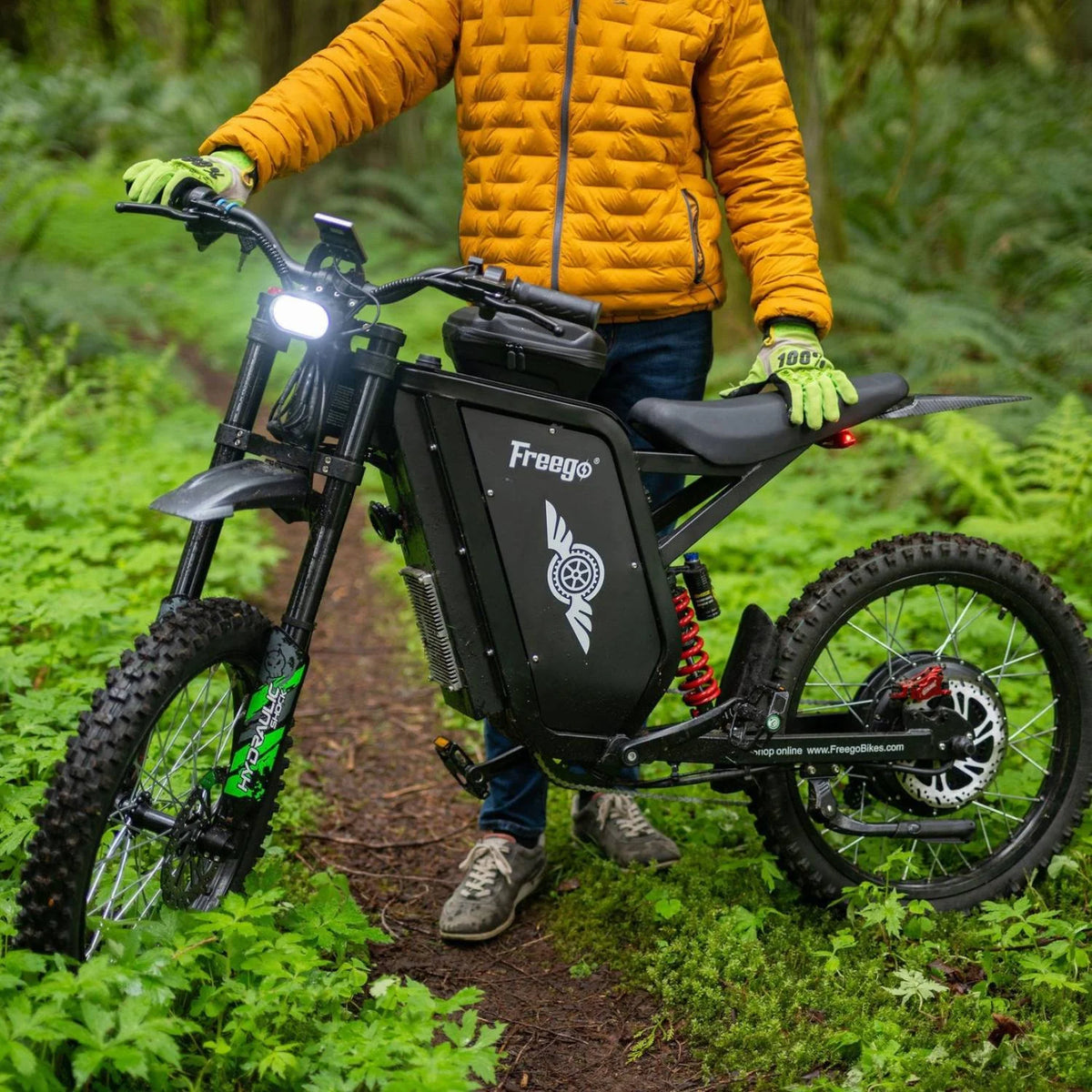 Freego X3 Pro electric dirt bike in a wooded riding setting