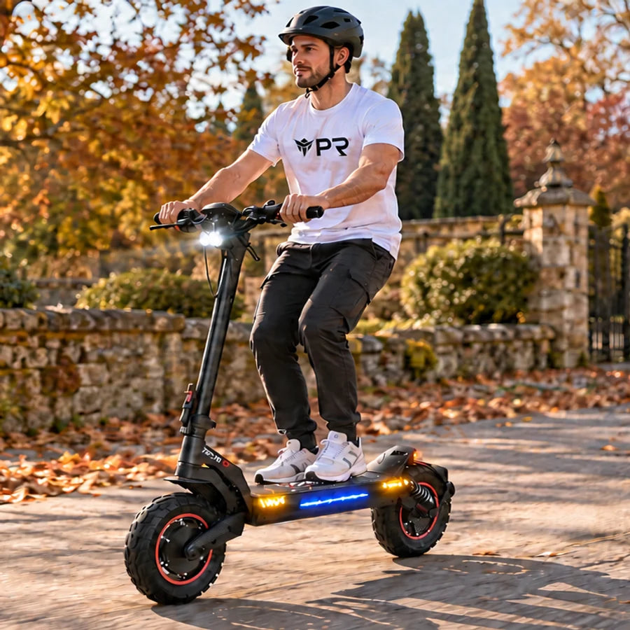 A helmeted rider wearing a white Punk Ride logo T-shirt uses the ISCOOTER iX7 Pro Electric Scooter in an autumn setting. Mobile collection banner.