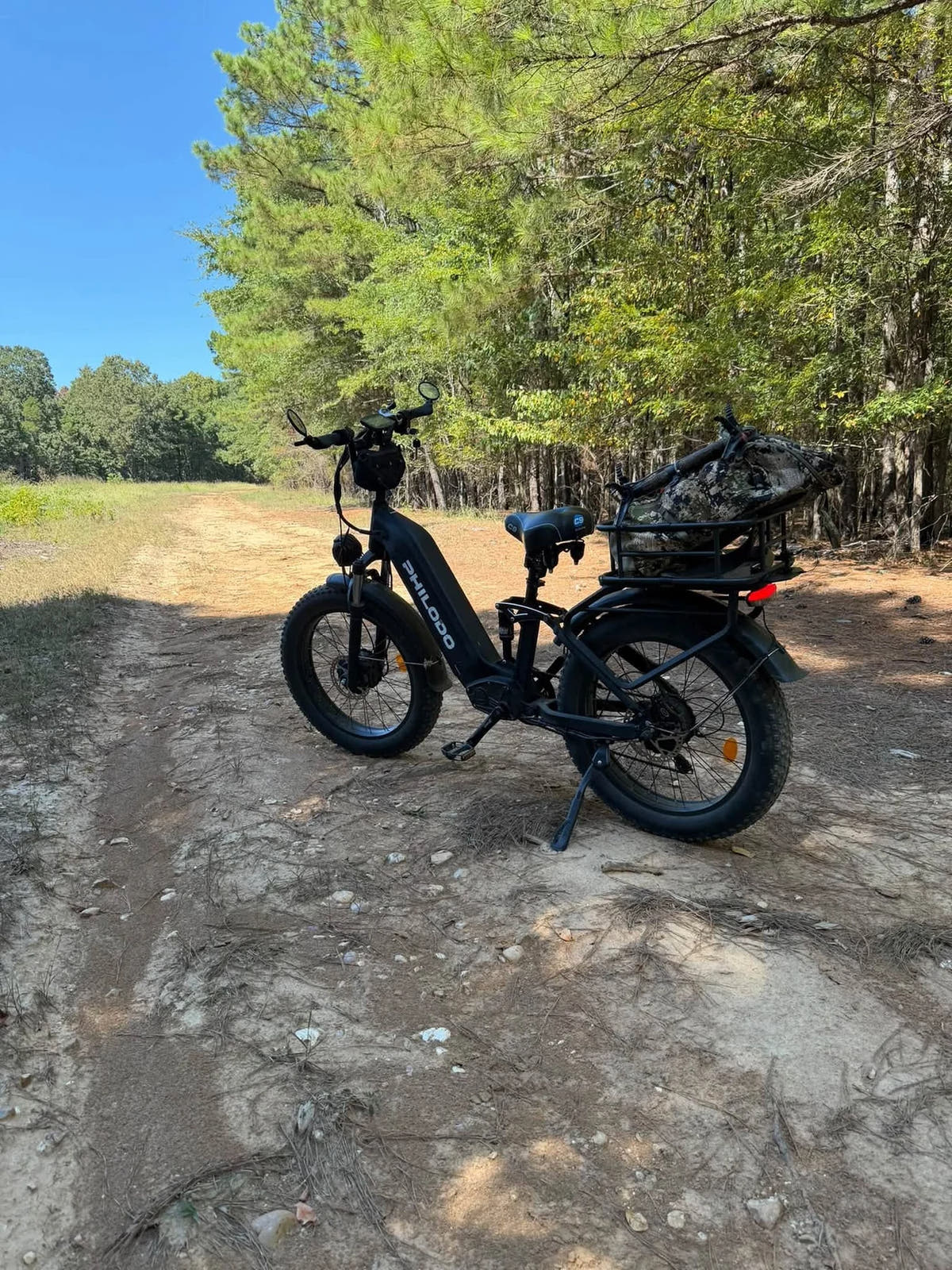 PHILODO Falcon Step-Thru Black electric bike on a woodland path