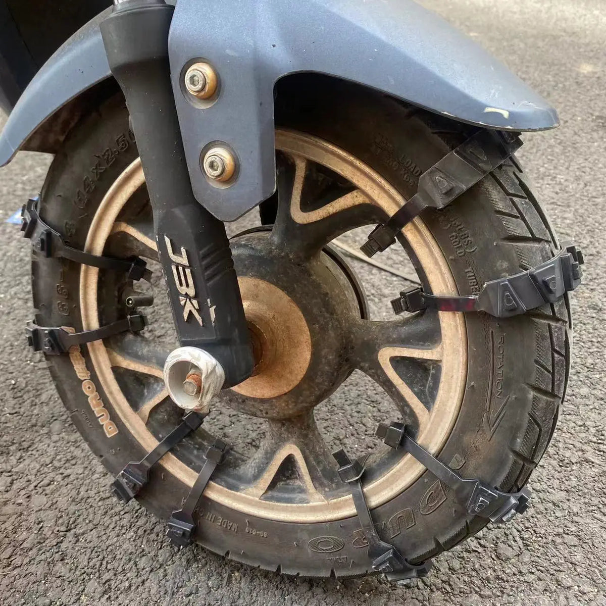 Black nylon tyre straps installed on a scooter tyre; fitting reference