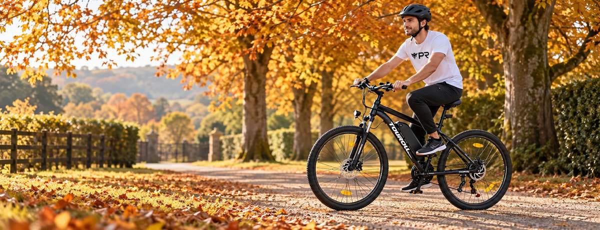 A helmeted rider wearing a white Punk Ride logo T-shirt rides the TOUROLL U1 Mountain Electric Bike in an autumn setting. Desktop collection banner.
