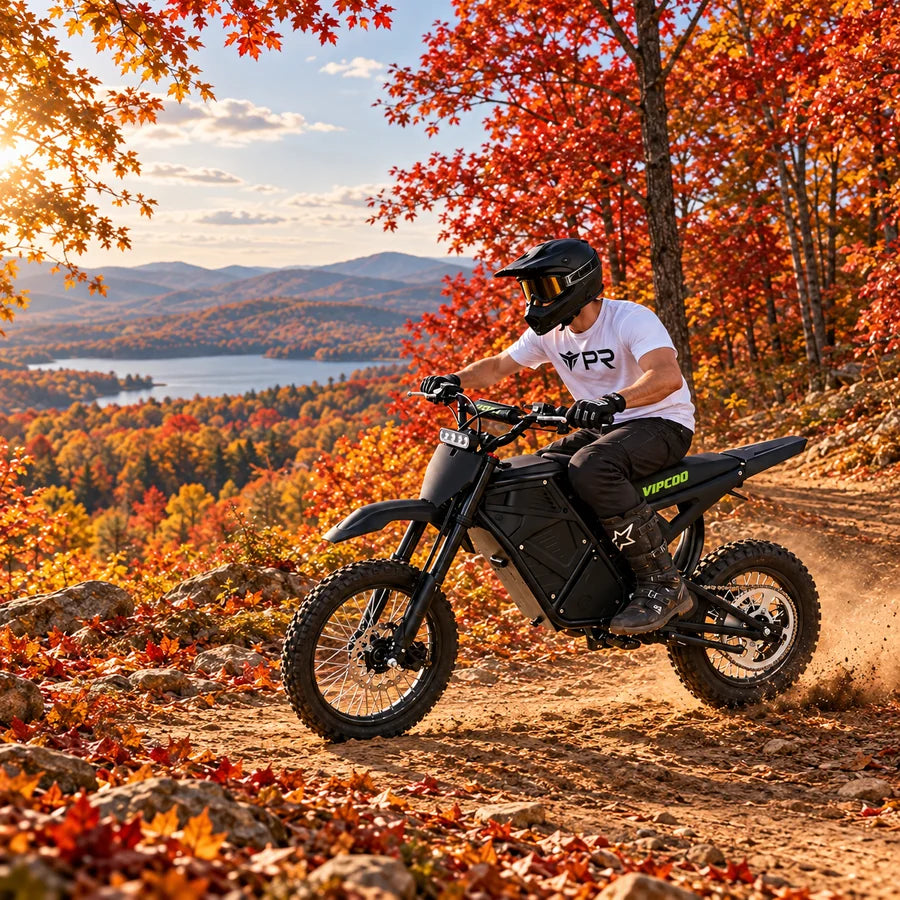 A helmeted rider wearing a white Punk Ride logo T-shirt rides the VIPCOO H3 Electric Dirt Bike in an autumn setting. Mobile collection banner.