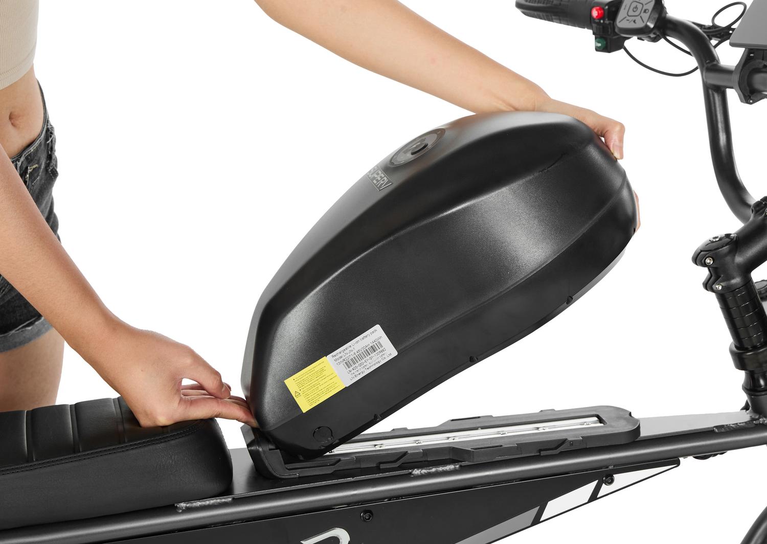 Person opening a black storage compartment on a scooter with a white background