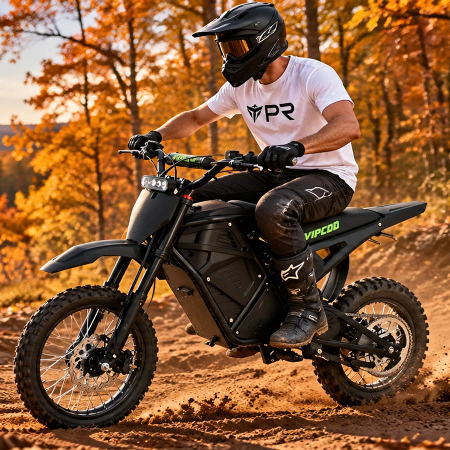 A helmeted rider wearing a white Punk Ride logo T-shirt rides the VIPCOO H3 Electric Dirt Bike in an autumn setting. Mobile collection banner.