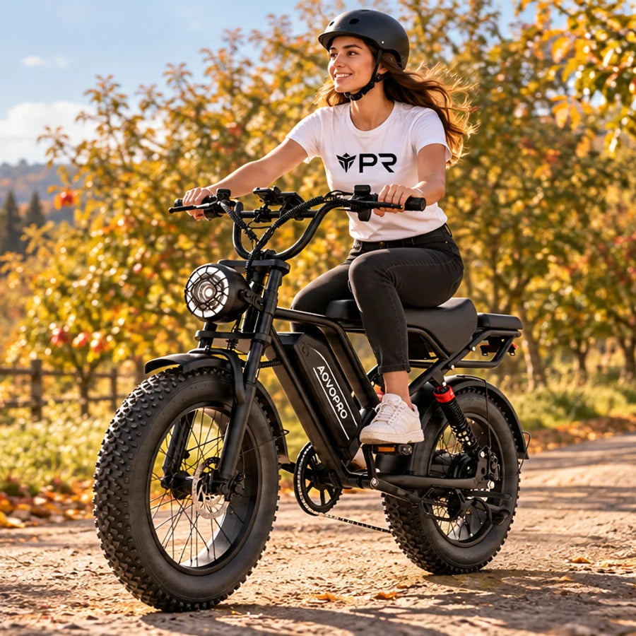 A helmeted rider wearing a white Punk Ride logo T-shirt rides the AOVOPRO AP20 / QLAWAY Electric Bike in an autumn setting. Mobile collection banner.