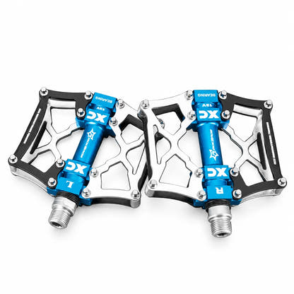 Silver and black bicycle pedal platforms with blue spindles on white background