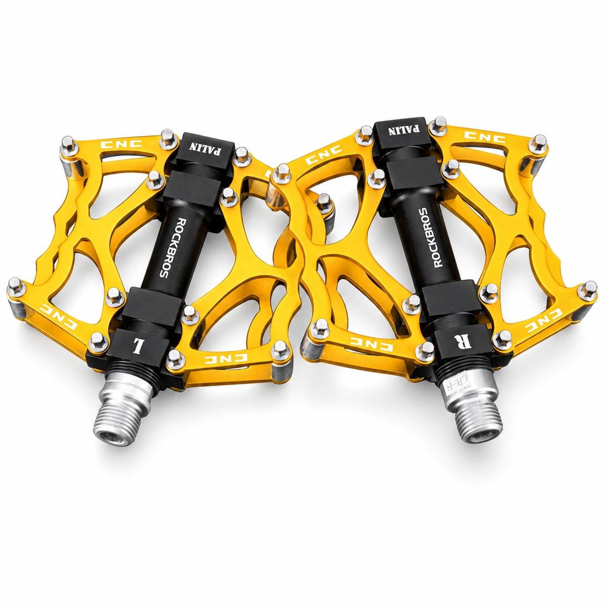 Golden bicycle platform pedal pair on white background