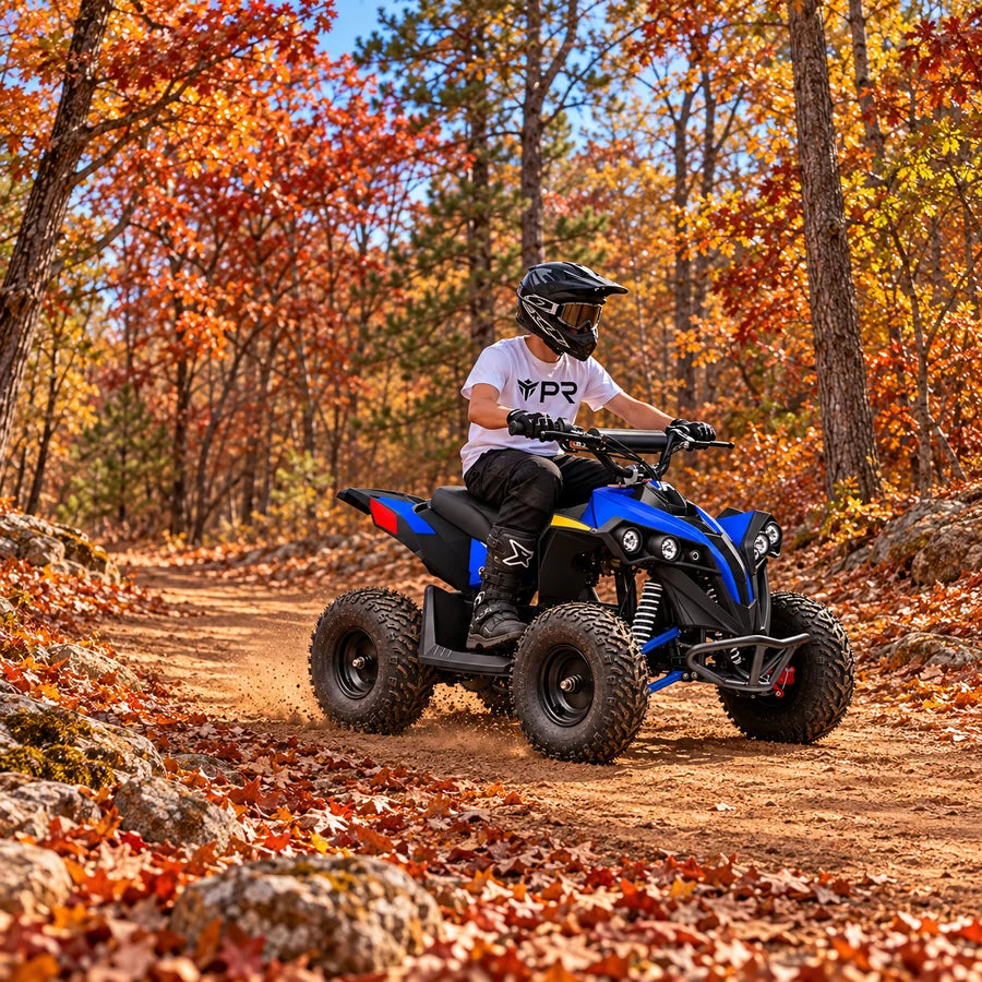 A helmeted rider wearing a white Punk Ride logo T-shirt uses the MotoTec E-Bully 36V 1000W ATV in an autumn setting. Mobile collection banner.