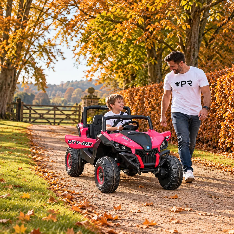 A child in a white Punk Ride logo T-shirt sits in a parked Mini Moto UTV 4x4 12V (2.4ghz RC) with an adult supervising in an autumn setting. Mobile collection banner.