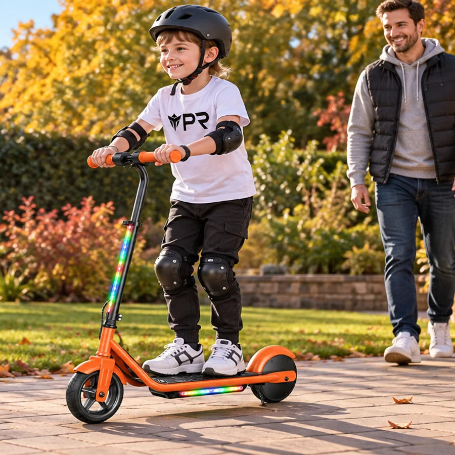 A helmeted rider wearing a white Punk Ride logo T-shirt rides the ISCOOTER K2 Pro Kids Electric Scooter in an autumn setting. Mobile collection banner.