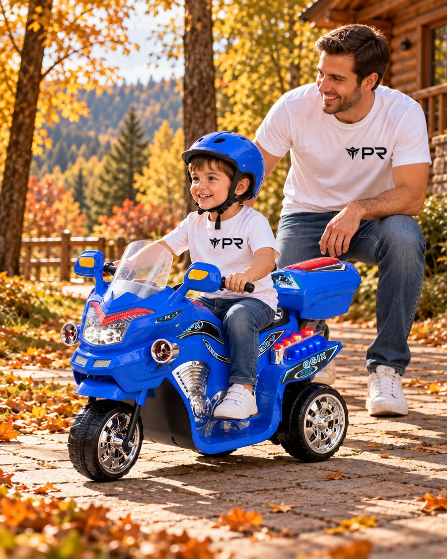 A helmeted child uses a blue three-wheel electric ride-on toy beside an adult in white Punk Ride logo T-shirts on an autumn woodland path.