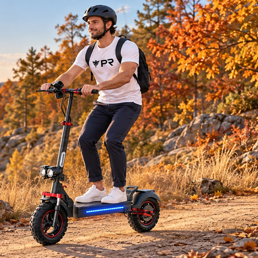 Helmeted rider wearing a white Punk Ride T-shirt, riding the ISCOOTER iX5S Scooter in an autumn setting.