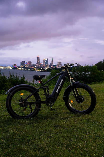 PHILODO Falcon Step-Thru Black electric bike near a city waterfront