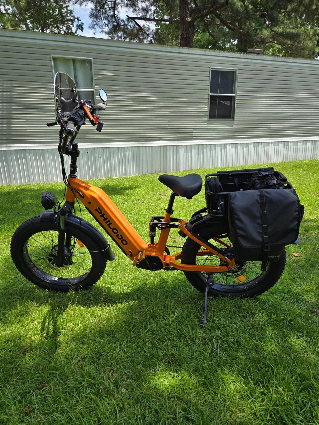 PHILODO Falcon Step-Thru Orange on grass with additional bags not included