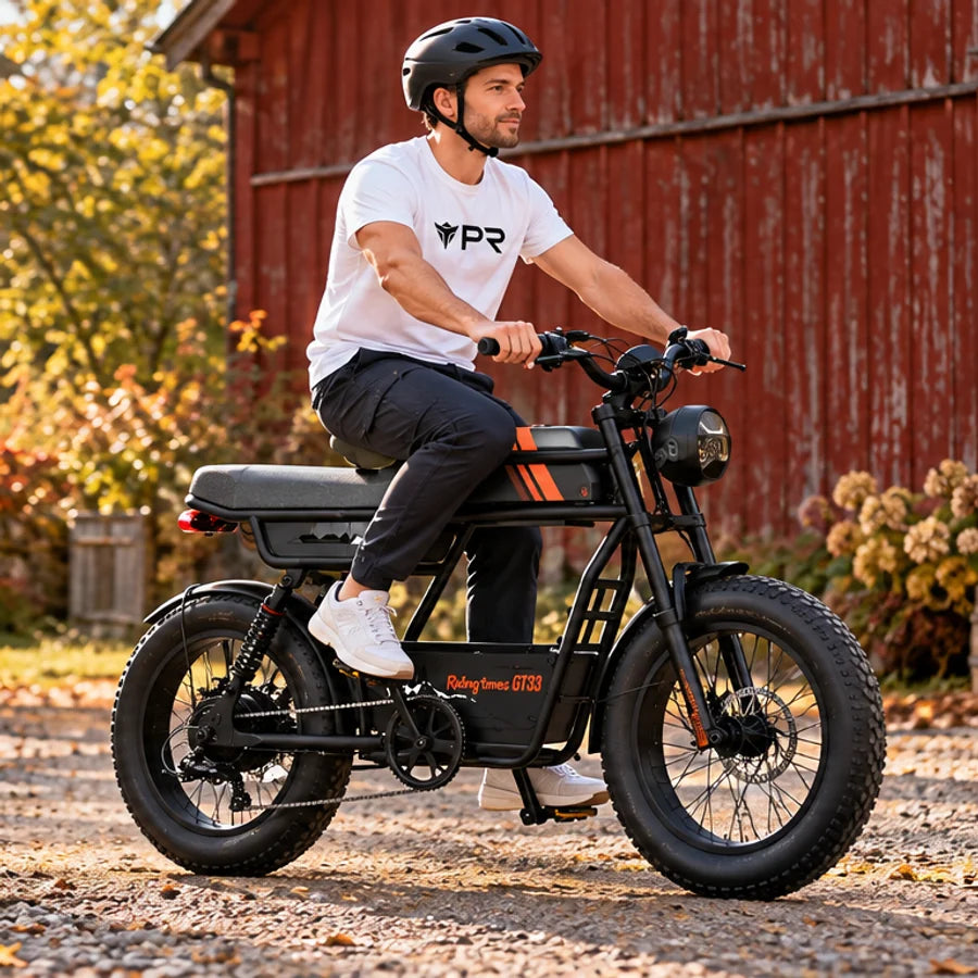 A helmeted rider wearing a white Punk Ride logo T-shirt rides the Riding Times GT33 Single-Battery Electric Cargo Bike in an autumn setting. Mobile collection banner.